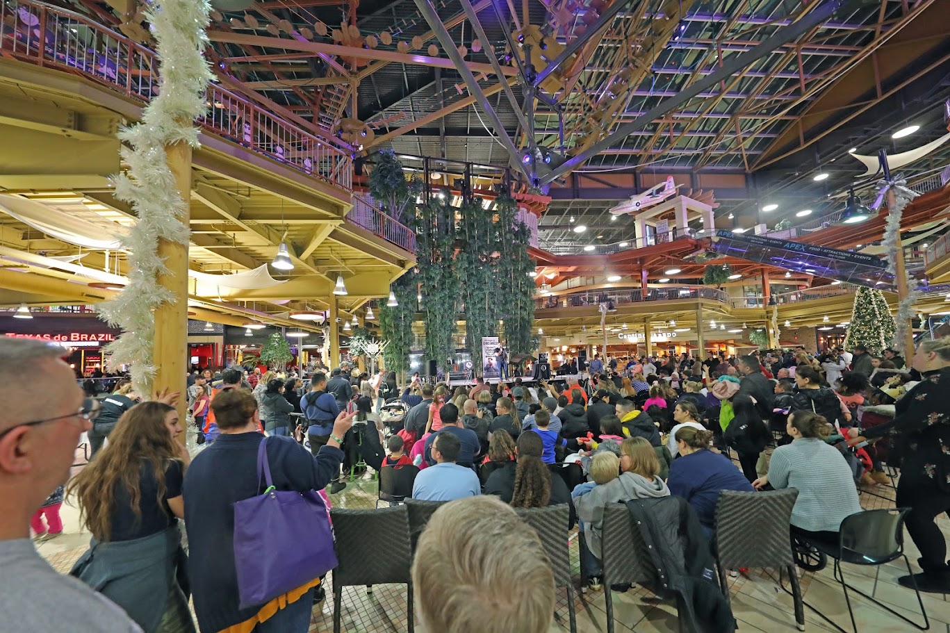 A large audience gathered in a multilevel venue for Chris Wheel’s magic show